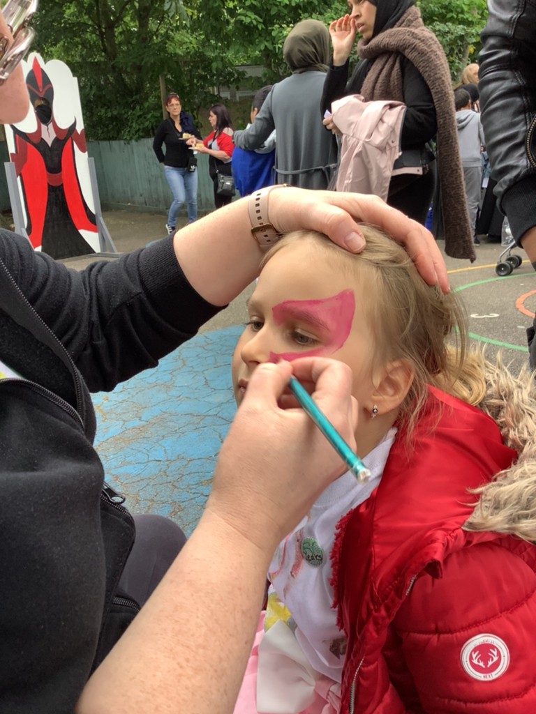 A child enjoying having their face painted